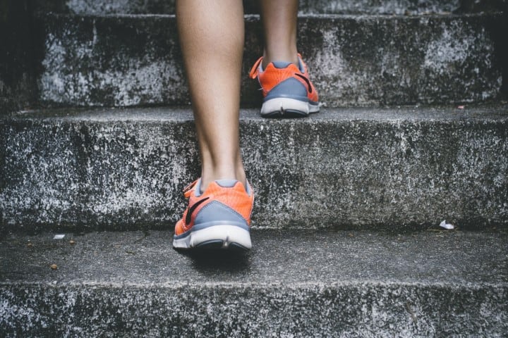 person walking up concrete stairs.bak person walking up concrete stairs